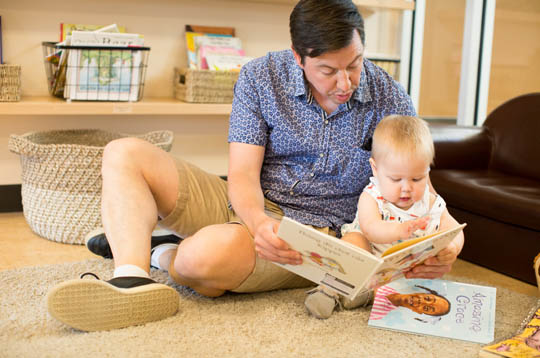Dad and a child reading a book